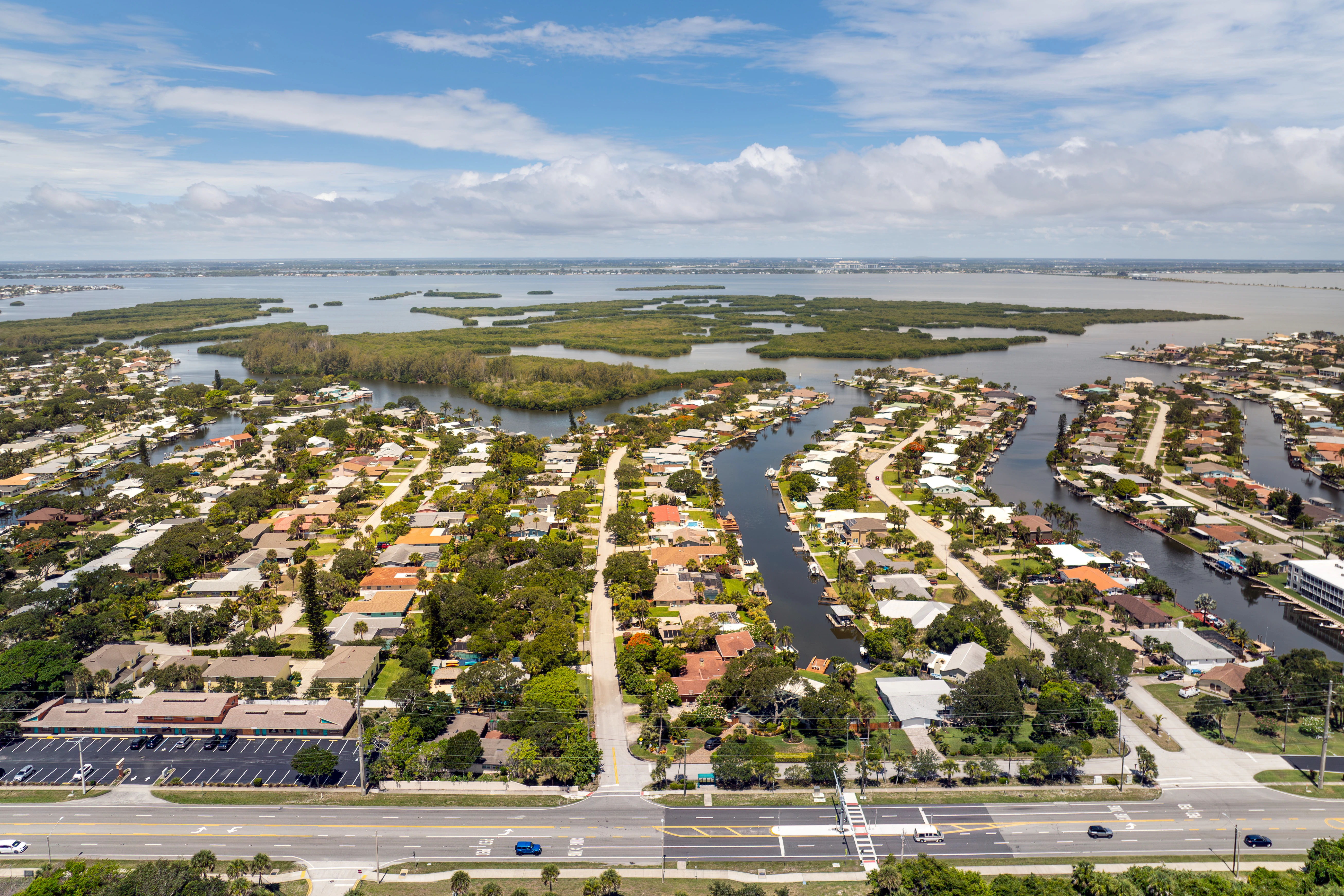 Aerial view of Cocoa Beach waterfront homes and canals with direct access to the Banana River, showing prime real estate locations.
