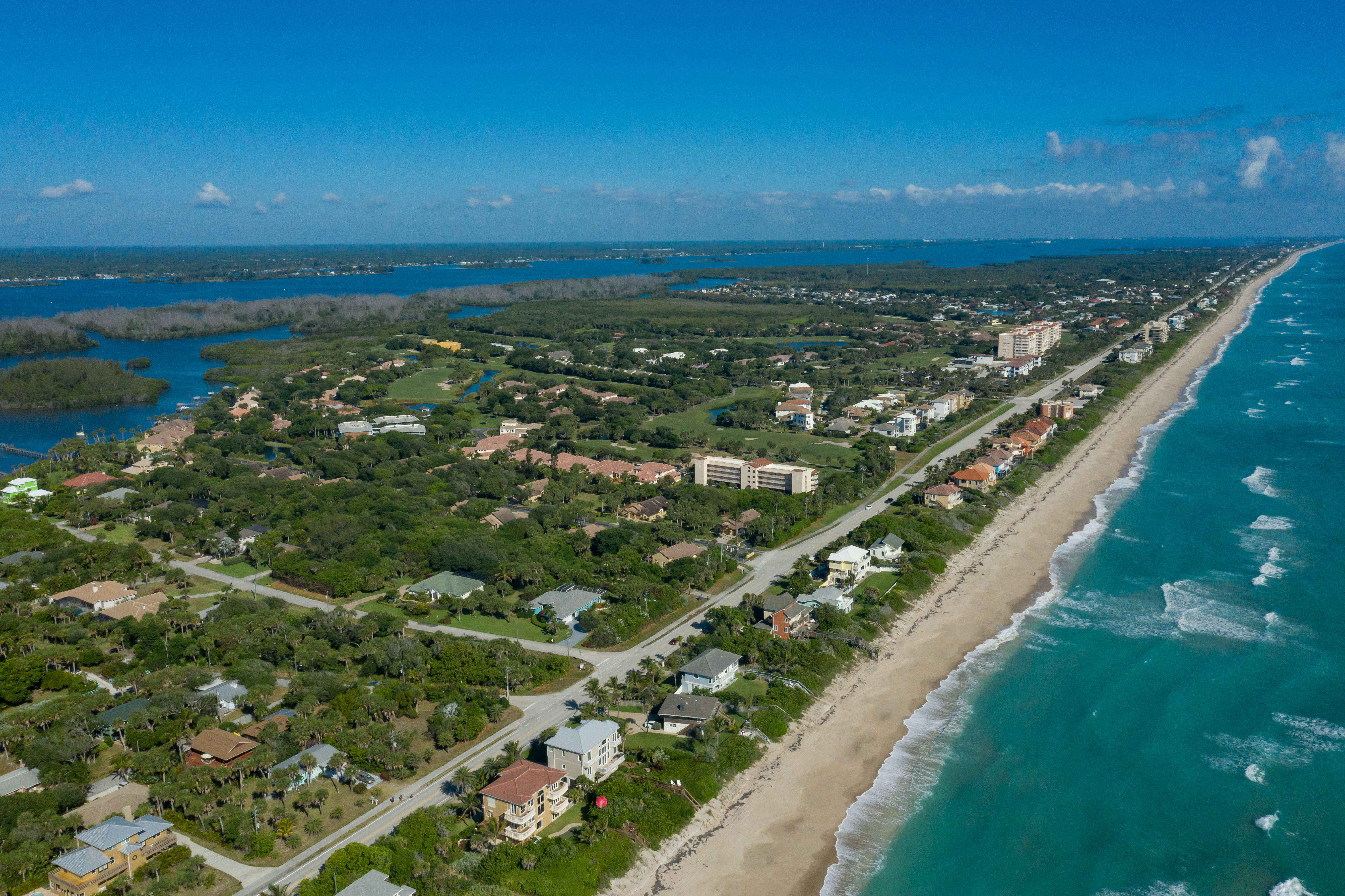 Aerial view of residential neighborhoods and beachfront properties along the Atlantic Ocean on Florida’s Space Coast, showcasing a thriving housing market in Brevard County.